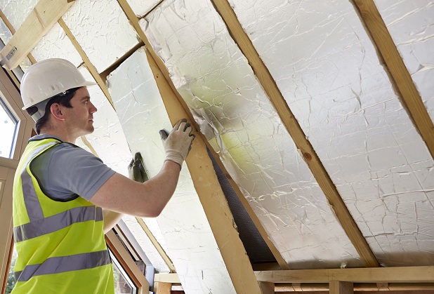 construction worker installing insulation 