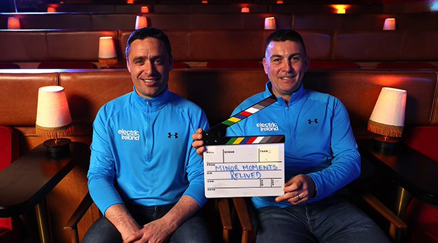 two men holding clapperboard