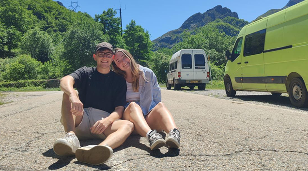 couple outside sitting on ground