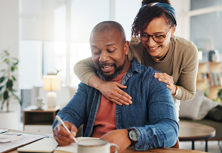 Happy couple checking their diary