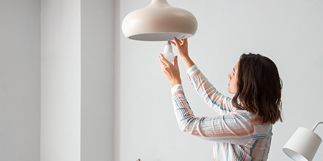 A woman changing a bulb
