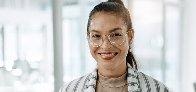 Happy young woman with glasses looking at camera